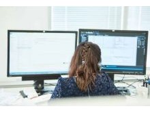 An engineering services staff member at her desk in the Vista Projects office